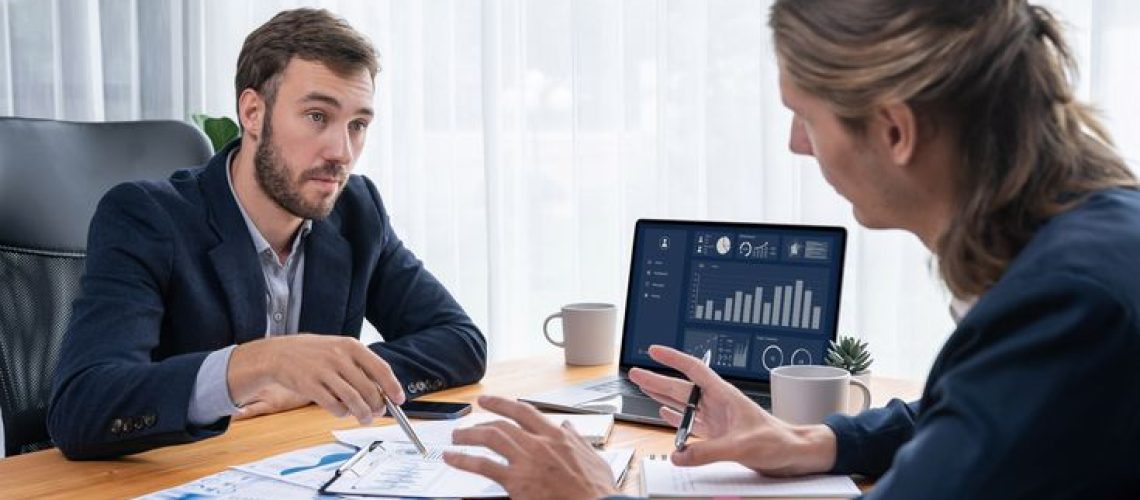 Busy analyst team in office analyzing financial data analysis for marketing strategy in workspace using BI dashboard with graph and chart on laptop screen to improve business performance. Entity